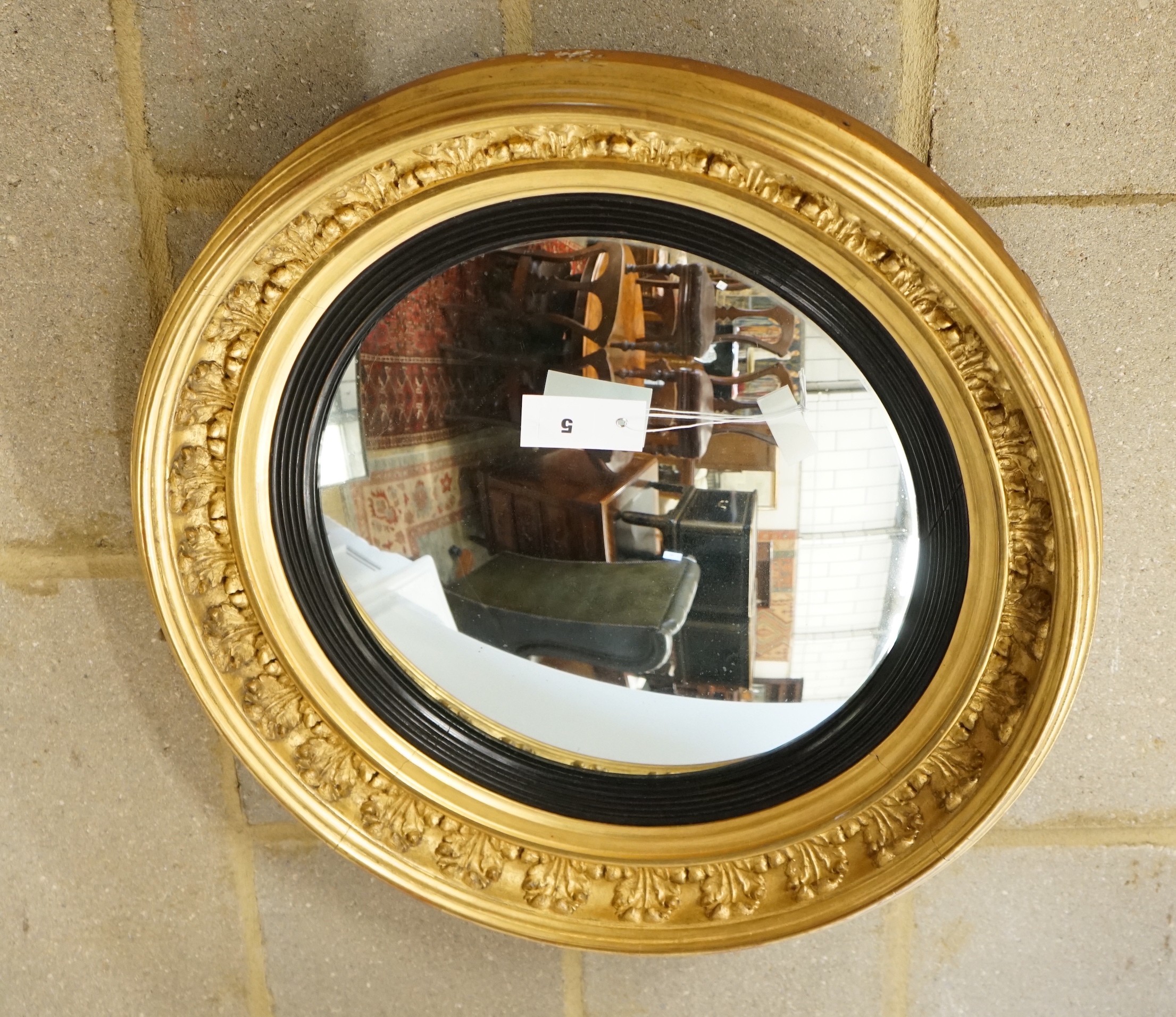 A Regency circular giltwood and gesso convex wall mirror, diameter 57cm